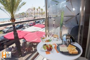 a table with a tray of food on a balcony at Hotel Boutique Estrella del Mar - Frente al mar, con desayuno, en el centro de Peñíscola in Peniscola