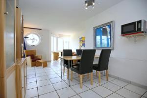 a dining room with a table and chairs at Dünenblick Wohnung 44 in Boltenhagen