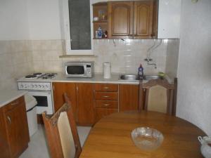 a small kitchen with a table and a microwave at Pansion Panorama Dubrovnik in Dubrovnik