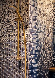 a shower in a bathroom with black and white tiles at Boutique Hotel Miramar in Monte Carlo