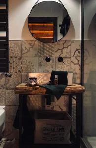 a counter in a bathroom with a mirror at B&B Il Fabbro Chambre in Castelmauro