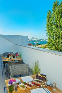 a table with plates of food on a balcony at Barbera Hotel in Istanbul