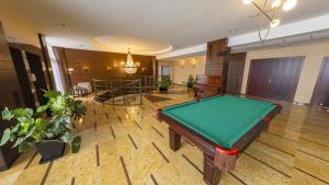 a pool table in the middle of a room at Hotel Leda Spa - Adults Only in Kołobrzeg