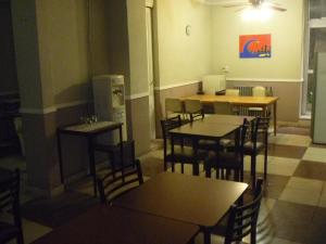 a restaurant with tables and chairs in a room at Hotel San Martin in Buenos Aires