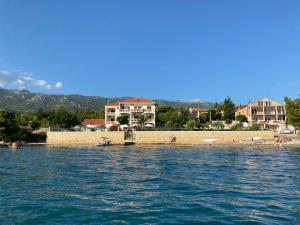 a group of people on a beach in the water at Villa Punta in Rovanjska