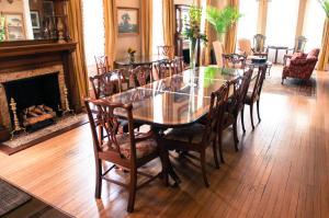 a dining room with a table and chairs and a fireplace at Kehoe House, Historic Inns of Savannah Collection in Savannah