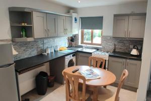 A kitchen or kitchenette at Luxury 'Cois Abhainn' Self Catering Apartment