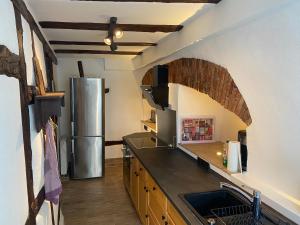 a kitchen with a sink and a refrigerator at Ferienwohnung Obergasse in Zwingenberg