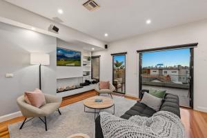 a living room with a couch and chairs at StayCentral - Moonee Ponds Penthouse in Melbourne