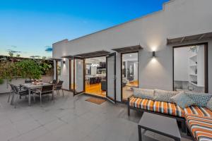 a living room with a couch and a table at StayCentral - Moonee Ponds Penthouse in Melbourne