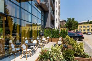 a row of tables and chairs in front of a building at Biography Design Tbilisi in Tbilisi City