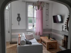 a living room with a couch and a table at LA CLOSERIE D'ISABAULT in Eu