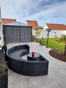 a patio with a fire pit in a yard at Chambres 2 caps in Ambleteuse