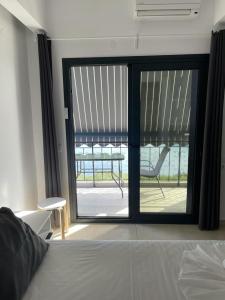 a bedroom with a sliding glass door to a patio at Pargas paradise in Parga