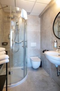 Et badeværelse på Hotel Leda Spa - Adults Only