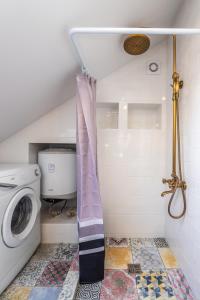 uma casa de banho com uma máquina de lavar roupa e uma máquina de lavar roupa. em Nida Urbas Hill Apartments em Nida