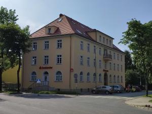 a large building with cars parked in front of it at VaBank in Bystrzyca Kłodzka