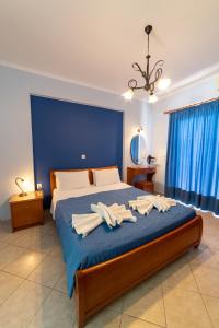 a bedroom with a large bed with towels on it at Studio Konstantinos in Parga