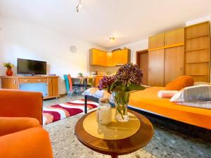 Pokój z łóżkiem i wazą kwiatów na stole w obiekcie Apartment Green Building w miejscowości Sveti Stefan