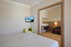 Телевизор и/или развлекательный центр в Hotel Rossini