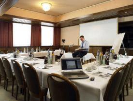 a man sitting on top of a table with a laptop at Hotel zur Post in Wettringen
