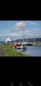 a group of boats are docked at a marina at Great Glen Way Canal Side Apartment in Inverness