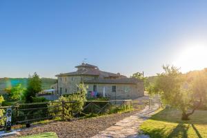 an old house with a fence in front of it at Agriturismo Concadoro in Castellina in Chianti