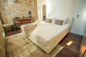 a bedroom with a large bed and a piano at CHARM by YoursPorto in Vila Nova de Gaia