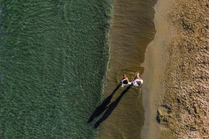 two people in a boat in the water on the beach at St Raphael Resort in Limassol