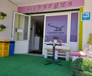 an entrance to a building with a table in front at Albergue Camiño Do Sar in Padrón