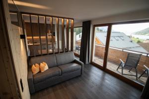 a living room with a couch and a large window at Haus Lechthaler in Resia