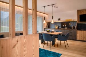 a kitchen and dining room with a table and chairs at Apt Lara Siela in Ortisei