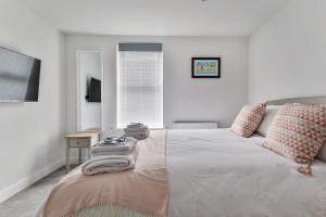 a bedroom with a bed with towels on it at Finest Retreats - 13 Belle House - Apartment 2 in Filey