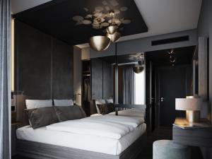 two beds in a room with black walls at AMANO East Side in Berlin