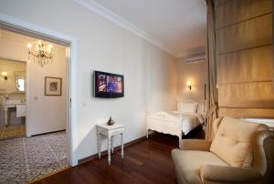 a living room with a bed and a couch at Hotel Sari Konak in Istanbul