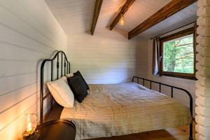 a bedroom with a bed in a house at A Tiny House Near The Beach in Pērkone