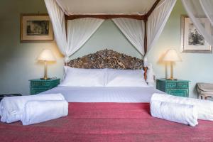 Säng eller sängar i ett rum på Villa Ape Rosa Relais