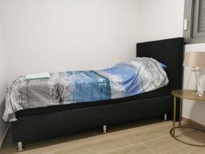 a bed with a black frame in a room at Greenhills La Zenia luxe penthouse 5 pers Orihuela in Los Dolses +11 photos