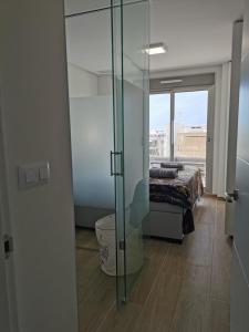 a room with a glass door with a bed in it at Greenhills La Zenia luxe penthouse 5 pers Orihuela in Los Dolses