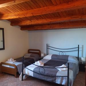 una camera con 2 letti e un soffitto in legno di Villa Nino a Marina di Ragusa