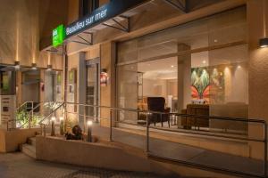 a store front of a building at night at ibis Styles Beaulieu sur Mer in Beaulieu-sur-Mer