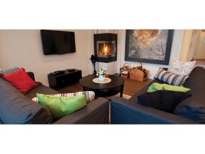 a living room with two couches and a fireplace at Svinö Waterfront Villa in Lumparland