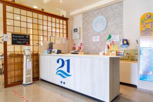 a restaurant with a counter in a store at Hotel 21 Riccione in Riccione