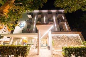 a building with lights on the side of it at Hotel 21 Riccione in Riccione