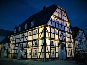 a large building with lit up windows at night at Haus Buuck - Herberge in Rüthen