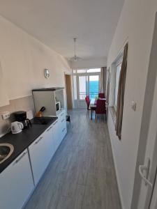 a kitchen and dining room with a view of the ocean at Apartments Lucic in Senj