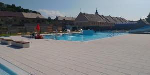 a large swimming pool with a water slide at Apartmán Náměstí Hostinné in Hostinné