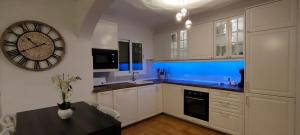 a kitchen with a large clock on the wall at Casa MALIBU in Son Bou