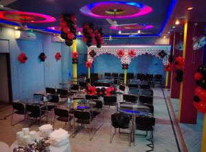 a banquet hall with tables and chairs and balloons at Hotel The Kings in Kota
