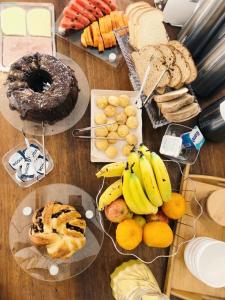 uma mesa com vários tipos diferentes de pão e pastelaria em Woman Trip Hostel Boutique - Arraial d´Ajuda em Arraial d'Ajuda